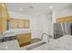 Well-lit kitchen featuring stainless steel appliances, granite countertops and light wood cabinetry at 5948 Sakhalin Ave, Las Vegas, NV 89139