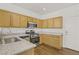 Well-equipped kitchen with stainless steel appliances, and light wooden cabinets at 5948 Sakhalin Ave, Las Vegas, NV 89139