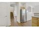 View of the kitchen and open floorplan features hardwood floors, stainless appliances, and natural light at 5948 Sakhalin Ave, Las Vegas, NV 89139