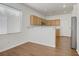 Open-concept kitchen featuring stainless steel appliances, light wood cabinets and breakfast bar at 5948 Sakhalin Ave, Las Vegas, NV 89139