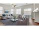 Bright living room featuring stylish furniture, ceiling fan, and sliding glass door at 5948 Sakhalin Ave, Las Vegas, NV 89139