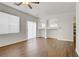 Open floorplan living room featuring hardwood floors and archways to the kitchen at 5948 Sakhalin Ave, Las Vegas, NV 89139