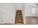 A hardwood staircase leads to the second level of the home with a white-painted wall at 5948 Sakhalin Ave, Las Vegas, NV 89139