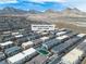 Aerial view of a residential area with mountain views in the distance; a community playground is also visible at 600 N Carriage Hill Dr # 1164, Las Vegas, NV 89138