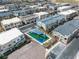 Aerial view showcasing a residential neighborhood featuring modern homes, a playground, and street parking at 600 N Carriage Hill Dr # 1164, Las Vegas, NV 89138