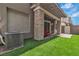 Cozy backyard with artificial grass, stone pillar covered porch, and outdoor seating, perfect for relaxing at 600 N Carriage Hill Dr # 1164, Las Vegas, NV 89138