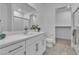 Bright bathroom features a large mirror, white cabinets, and a walk-in shower with tile surround at 600 N Carriage Hill Dr # 1164, Las Vegas, NV 89138
