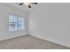 This carpeted bedroom offers a ceiling fan and sunlit window at 600 N Carriage Hill Dr # 1164, Las Vegas, NV 89138