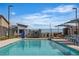 Community pool with sun loungers and umbrellas, ideal for relaxing and enjoying sunny days at 600 N Carriage Hill Dr # 1164, Las Vegas, NV 89138