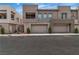 Modern townhome exterior with stone accents, well-maintained landscaping, and two-car garage at 600 N Carriage Hill Dr # 1164, Las Vegas, NV 89138