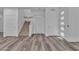 Bright foyer featuring a private elevator, wooden staircase, and gray laminate flooring at 600 N Carriage Hill Dr # 1164, Las Vegas, NV 89138
