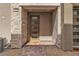 Inviting front entrance with stone accents, modern door, and paved walkway at 600 N Carriage Hill Dr # 1164, Las Vegas, NV 89138