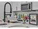 Close up of kitchen with stainless steel appliances, white countertops and modern faucet at 600 N Carriage Hill Dr # 1164, Las Vegas, NV 89138