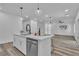 Modern kitchen features quartz countertops, stainless steel appliances, and a seamless transition to the living room at 600 N Carriage Hill Dr # 1164, Las Vegas, NV 89138