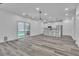 Open concept with modern light fixture, kitchen island, and sliding glass door to the backyard at 600 N Carriage Hill Dr # 1164, Las Vegas, NV 89138