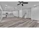 Open-concept living area with gray laminate floors, a modern kitchen and staircase to the second floor at 600 N Carriage Hill Dr # 1164, Las Vegas, NV 89138