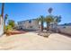 Backyard showcasing mature trees, a large patio, and clear blue skies at 6710 Redwood Cir, Las Vegas, NV 89103