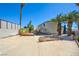 Expansive backyard featuring a concrete patio and mature palm trees at 6710 Redwood Cir, Las Vegas, NV 89103