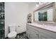 Well-lit bathroom featuring custom vanity, a large mirror, and toilet at 6710 Redwood Cir, Las Vegas, NV 89103