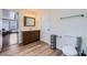 Well-lit bathroom with a wooden vanity, framed mirror, and tile floors at 6710 Redwood Cir, Las Vegas, NV 89103