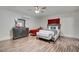 Sunlit bedroom featuring ceiling fan, wood floors, and stylish furniture at 6710 Redwood Cir, Las Vegas, NV 89103