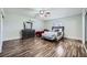 Bright bedroom featuring wood floors, ceiling fan and stylish furniture at 6710 Redwood Cir, Las Vegas, NV 89103