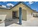 Front porch of a single-story home featuring blue trim, secure metal security door and desert landscaping at 6710 Redwood Cir, Las Vegas, NV 89103