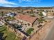 Aerial view of a backyard featuring an inground pool, desert landscaping, and lush greenery at 78 Siddall Ave, Las Vegas, NV 89183