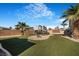 Expansive backyard with artificial turf, gravel landscaping, mature palms, and an RV parking area at 78 Siddall Ave, Las Vegas, NV 89183