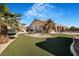 Backyard features manicured artificial turf and mature landscaping, and plenty of room for relaxing and entertaining at 78 Siddall Ave, Las Vegas, NV 89183