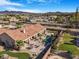 Aerial view of backyard featuring a pool, patio, and lush landscaping with mountain views at 78 Siddall Ave, Las Vegas, NV 89183