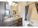 Bathroom featuring a granite vanity with dark cabinets and a shower with a dark curtain at 78 Siddall Ave, Las Vegas, NV 89183