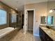 Bathroom showcasing a soaking tub, walk-in shower, and granite countertops at 78 Siddall Ave, Las Vegas, NV 89183