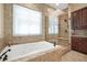 Bathroom featuring a soaking tub, glass enclosed shower, and granite finishes at 78 Siddall Ave, Las Vegas, NV 89183