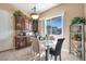 A dining room with a glass table and a view of trees outside the window at 78 Siddall Ave, Las Vegas, NV 89183