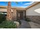 Inviting front entrance featuring stone accents, a gated entry, and mature landscaping with a walkway at 78 Siddall Ave, Las Vegas, NV 89183