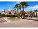 Charming single-story home with mature palm trees, desert landscaping and a well-manicured lawn at 78 Siddall Ave, Las Vegas, NV 89183