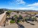 Expansive view of a charming home with desert landscaping, palm trees, and a two-car garage at 78 Siddall Ave, Las Vegas, NV 89183