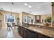 Bright kitchen features granite counters, dark wood cabinets, and a breakfast nook with natural light at 78 Siddall Ave, Las Vegas, NV 89183