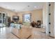 Living room with tile floors, neutral walls, and seating by a bright window at 78 Siddall Ave, Las Vegas, NV 89183