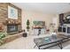 Inviting living room features stone fireplace, tiled floor, media center and adjacent wet bar at 78 Siddall Ave, Las Vegas, NV 89183