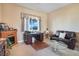 Bright home office featuring a fireplace, desk, and comfortable seating at 78 Siddall Ave, Las Vegas, NV 89183