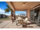 Covered outdoor patio with a ceiling fan and a dining table with four chairs at 78 Siddall Ave, Las Vegas, NV 89183