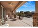 Covered patio with ceiling fan, stone pillars, seating, and a partial view of the pool area at 78 Siddall Ave, Las Vegas, NV 89183