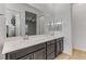 Bathroom with double vanity, modern cabinetry, and a view into the bedroom and walk-in closet at 783 Hibiscuss Blossom St, Henderson, NV 89011
