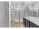 Bright bathroom featuring a glass-enclosed shower and a double vanity with modern cabinetry and fixtures at 783 Hibiscuss Blossom St, Henderson, NV 89011