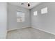 Neutral bedroom featuring carpet floors, multiple windows for natural light, and a ceiling fan at 783 Hibiscuss Blossom St, Henderson, NV 89011