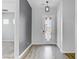 Bright foyer featuring wood-look floors, decorative front door with glass accents, and light gray accent wall at 783 Hibiscuss Blossom St, Henderson, NV 89011