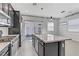 Stylish kitchen features a large island with granite countertops, stainless steel appliances, and dark cabinetry at 783 Hibiscuss Blossom St, Henderson, NV 89011