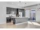 Well-equipped kitchen with stainless steel appliances, granite counters, dark cabinets, and island with sink at 783 Hibiscuss Blossom St, Henderson, NV 89011